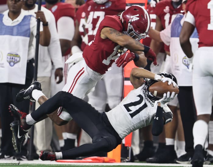 Cincinnati Bearcats receiver Tyler Scott (21) makes a reception against Alabama Crimson Tide cornerback Brian Branch (14) during the 2021 Cotton Bowl college football CFP national semifinal game at AT&T Stadium.